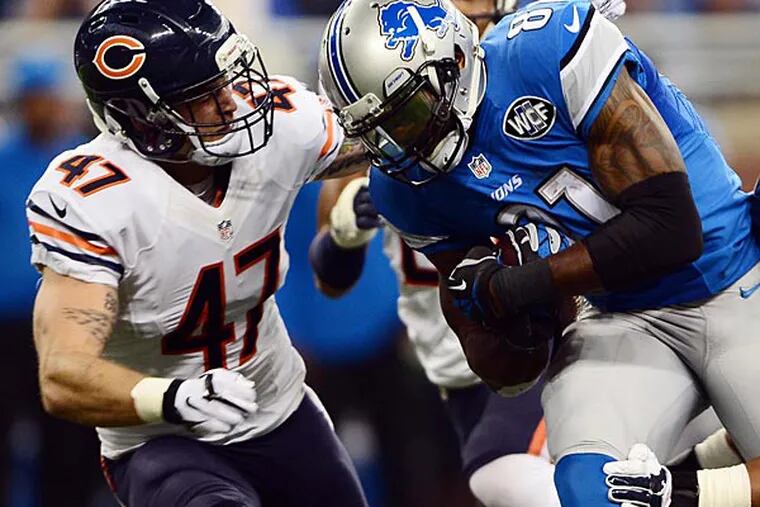 Detroit Lions wide receiver Calvin Johnson (81) is tackled by Chicago Bears free safety Chris Conte (47) and inside linebacker Jon Bostic (57) during the first quarter at Ford Field. (Andrew Weber/USA Today)