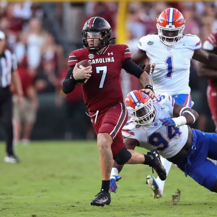 South Carolina quarterback Spencer Rattler (7) runs for a first down past Florida defensive lineman Tyreak Sapp (94) during the second half of an NCAA college football game Saturday, Oct. 14, 2023, in Columbia, S.C. (AP Photo/Artie Walker Jr.)