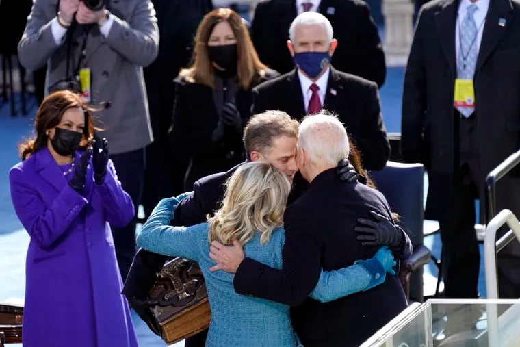 President Joe Biden hugs first lady Jill Biden, his son Hunter Biden and daughter Ashley Biden after being sworn-in during the 59th Presidential Inauguration. Vice President Kamala Harris applauds at left.