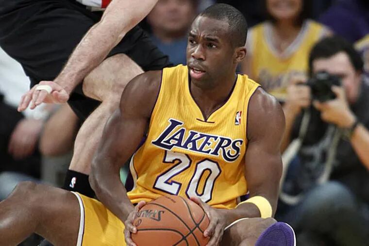 Los Angeles Lakers guard Jodie Meeks (20) looks for an opening against
Portland Trail Blazers forward Joel Freeland (19), of England, during
the fourth quarter of an NBA basketball game, Friday, Dec. 28, 2012,
in Los Angeles. Lakers won the game 104-87. (AP Photo/Alex Gallardo)