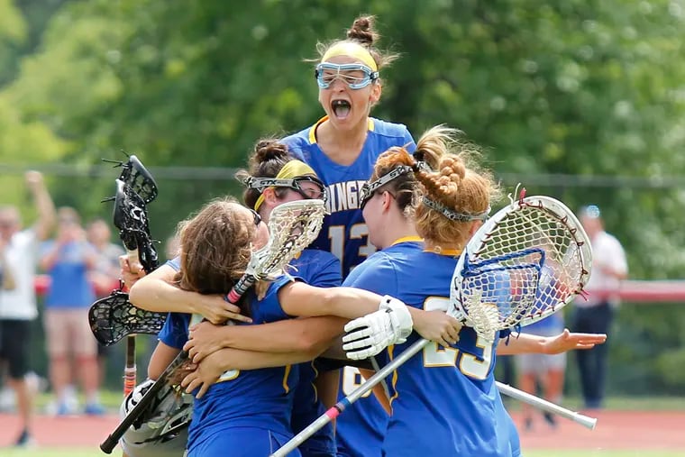 Springfield (Delco) defender McKayla Cox (13) and teammates celebrate after winning the PIAA Class 2A lacrosse championship Saturday, June 8, 2019, at West Chester East. The Cougars defeated Villa Maria in the final, 10-8.