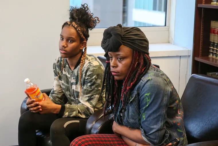 Thirteen-year-old Jasmin Samba, left, and her mother, Marie Samba, sit in the office of their attorneys, Thomas Kenny and Eileen Burns, in Philadelphia.