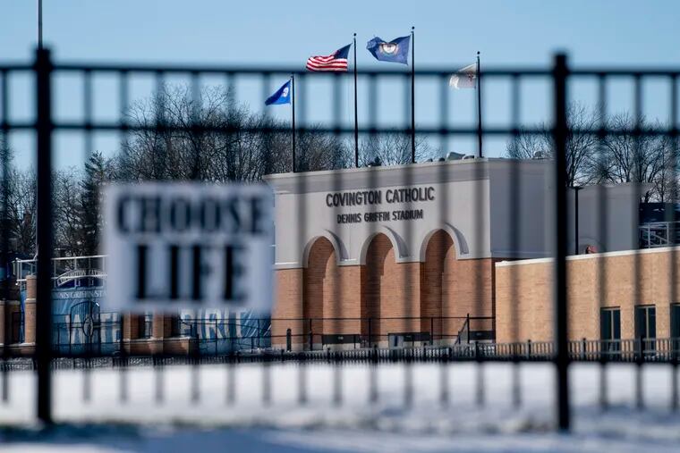 Flags fly over the Covington Catholic High School stadium in Park Kills, Ky., Sunday, Jan 20, 2019. A diocese in Kentucky has apologized after videos emerged showing students from the Catholic boys' high school in conflict with Native Americans outside the Lincoln Memorial on Friday after a rally in Washington.