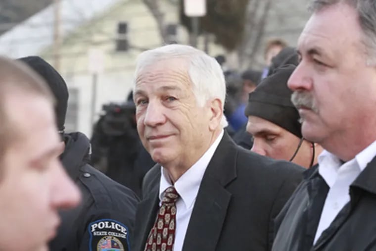 Former Penn State football defensive coordinator Jerry Sandusky is escorted into the Centre County Courthouse in Bellefonte, Pa. (David Swanson / Staff Photographer)
