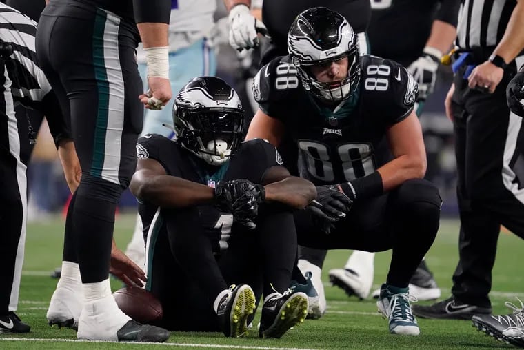 Philadelphia Eagles wide receiver A.J. Brown (center) sits on the turf after injuring his knee in last week's game at Dallas. Brown is questionable for Sunday's battle with the New Orleans Saints at Lincoln Financial Field. (Photo by Sam Hodde/Getty Images)