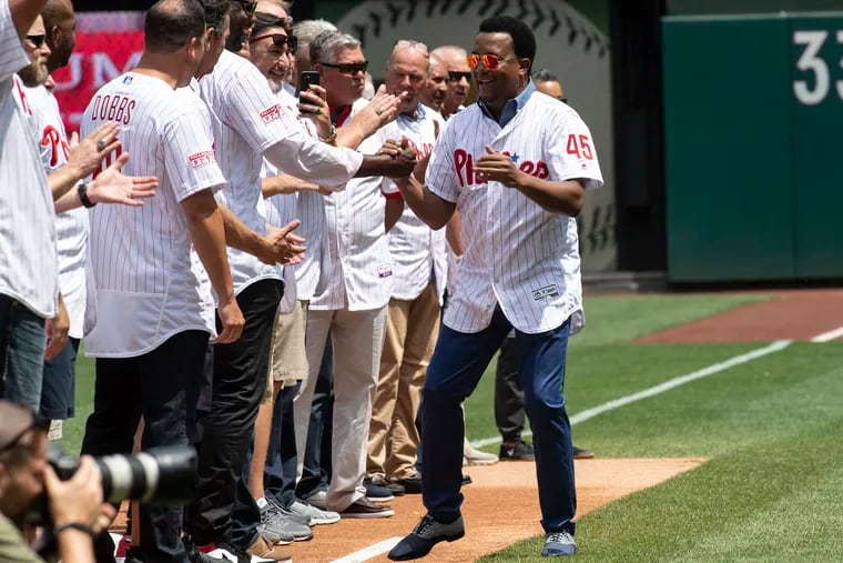 Former Phillies pitcher Pedro Martinez salutes team-mates during a ceremony honoring the 2009 Phillies Alumni Sunday, Aug. 4, 2019, in Philadelphia.