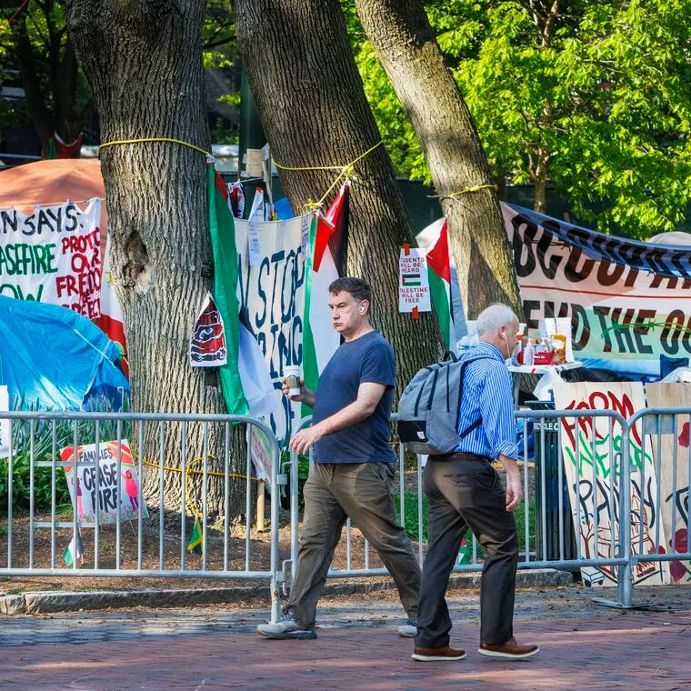 Pedestrians making way past a Pro-Palestine encampment on the campus of the University of Pennsylvania in April.