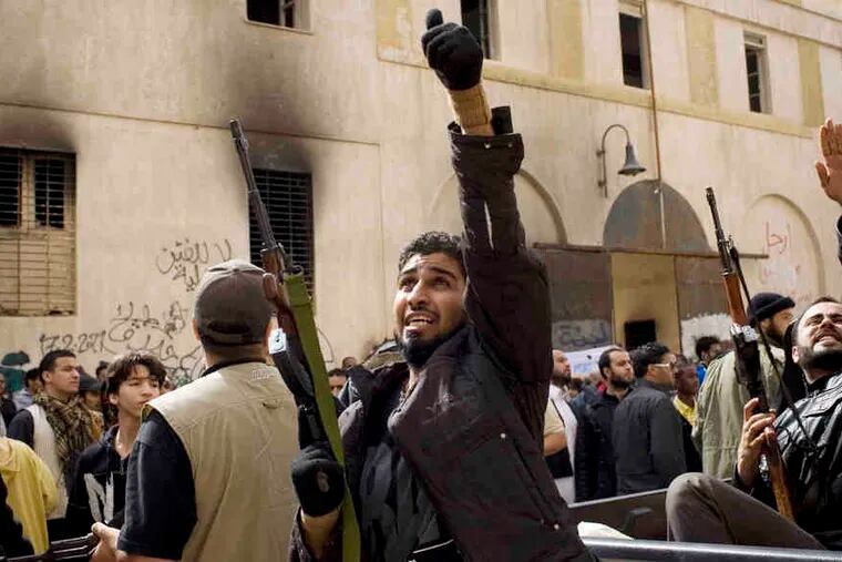 Armed Libyans celebrate in the center of rebel-controlled Benghazi hours after the U.N. Security Council approved a no-fly zone and other measures to protect civilians from attacks.
