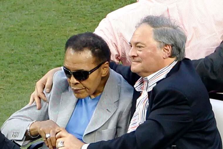Muhammad Ali, left, rides onto the field with Miami Marlins owner Jeffrey Loria during Opening Day events before a baseball game between the Miami Marlins and the St. Louis Cardinals, Wednesday, April 4, 2012, in Miami. (AP Photo/Wilfredo Lee)