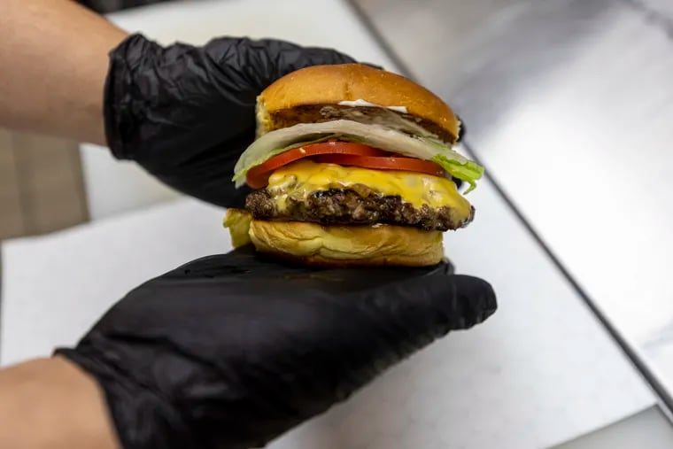 At Spot Gourmet Burgers in Brewerytown, a 6-ounce cheeseburger costs several dollars more than it did pre-pandemic, due in part to rising beef costs.