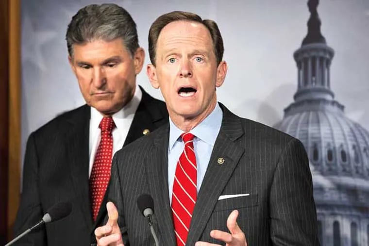 Sen. Joe Manchin, D-W.Va. listens at left, as Sen. Patrick Toomey, R-Pa. announce that they have reached a bipartisan deal on expanding background checks to more gun buyers, Wednesday, April 10, 2013, on Capitol Hill in Washington.  (AP Photo/J. Scott Applewhite)