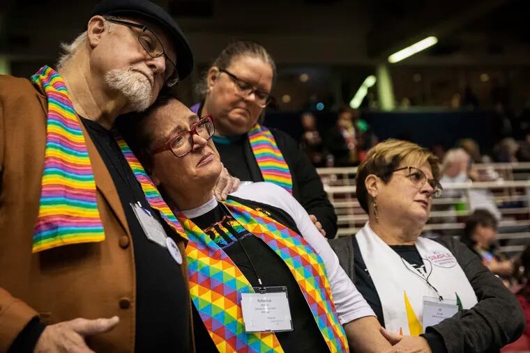 Ed Rowe, left, Rebecca Wilson, Robin Hager and Jill Zundel, react to the defeat of a proposal that would allow LGBT clergy and same-sex marriage within the United Methodist Church at the denomination’s 2019 Special Session of the General Conference in St. Louis, Mo., Tuesday, Feb. 26, 2019. America’s second-largest Protestant denomination faces a likely fracture as delegates at the crucial meeting move to strengthen bans on same-sex marriage and ordination of LGBT clergy.