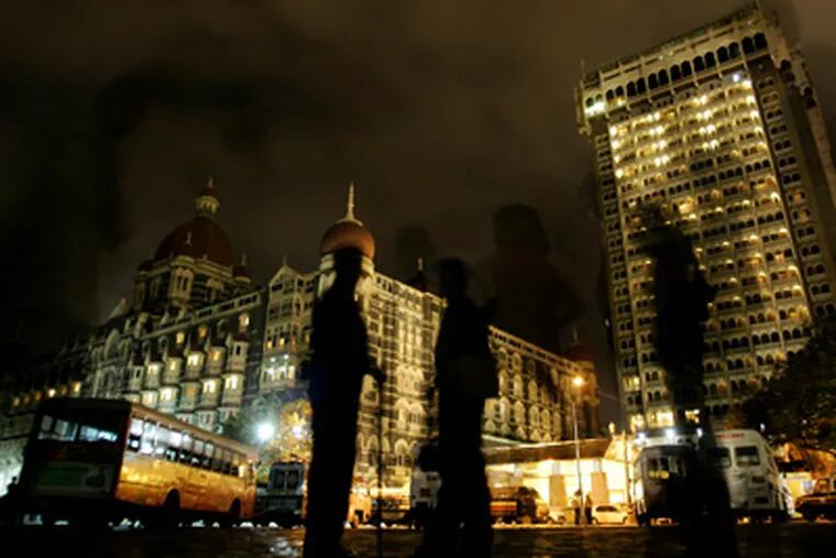 Indian paramilitary soldiers stand guard at the Taj Mahal hotel in Mumbai, India, on Nov. 29, 2008, after Indian commandos killed the last remaining gunmen holed up at a luxury Mumbai hotel, ending a 60-hour rampage through India's financial capital by suspected Islamic militants. (AP Photo/Altaf Qadri)