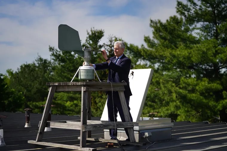 Donald Dvorin collects a pollen sample from a trap on the roof of his practice in the spring of 2021.