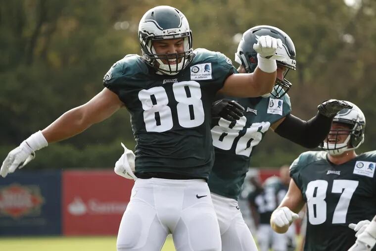 The Eagles’ Trey Burton, left, celebrates with Zach Ertz, center, after catching a pass during Eagles training camp last week.