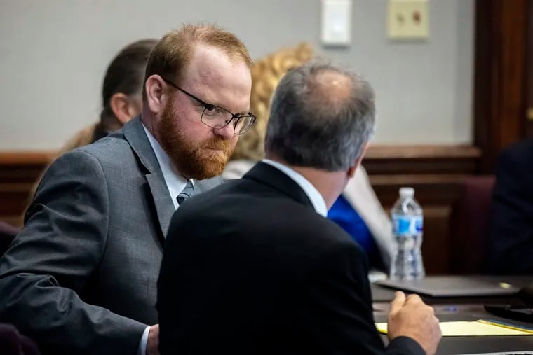Defendant Travis McMichael speaks with his attorney Bob Rubin while they wait for the jury to return to the courtroom during the trial of McMichel and his father, Greg McMichael, and a neighbor, William "Roddie" Bryan in the Glynn County Courthouse on Wednesday in Brunswick, Ga. The three are charged with the February 2020 slaying of 25-year-old Ahmaud Arbery.