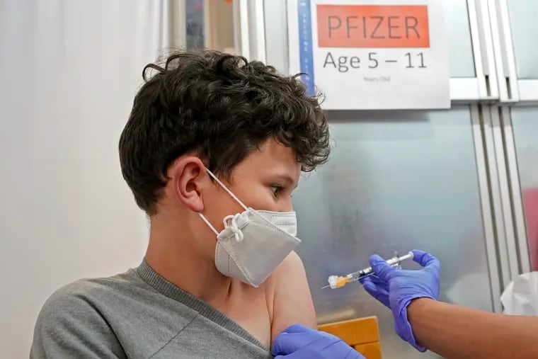 Leo Hahn, 11, gets the first shot of the Pfizer COVID-19 vaccine, Tuesday, Nov. 9, 2021, at the University of Washington Medical Center in Seattle. Last week, U.S. health officials gave the final signoff to Pfizer's kid-size COVID-19 shot, a milestone that opened a major expansion of the nation's vaccination campaign to children as young as 5.
