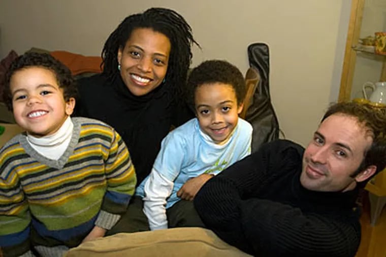 'I want my boys to be proud to be black, proud to be Spanish,' says Lori Tharps, with sons Addai , 4, Esai, 7, and husband Manuel  in their Mt. Airy home. (Ron Tarver / Staff Photographer)