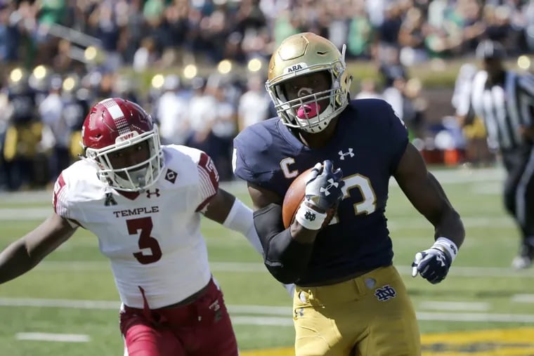 Notre Dame running back Josh Adams (33) sprints to the end zone for a touchdown past Temple defensive back Sean Chandler (3) and Mike Jones (10) during the first half Sept. 2 in South Bend, Ind.
