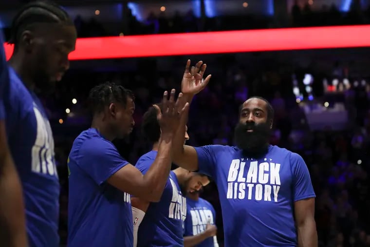 Philadelphia 76ers guard James Harden high-fives his teammates after the National Anthem before the start of a game against the Orlando Magic at the Wells Fargo Center in Philadelphia on Wednesday, Feb. 1, 2023.
