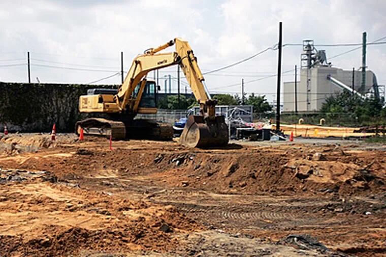 Workers remove contaminated soil at the Welsbach/General Gas Mantle Superfund site at Fourth and Jefferson Streets in Camden in 2009. (Michael Bryant / Staff Photographer)