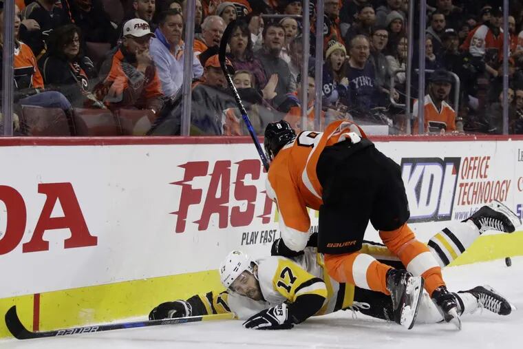 Flyers’ defenseman Robert Hagg hits Penguins’ forward Bryan Rust during the Flyers’ 5-2 loss on Wednesday.