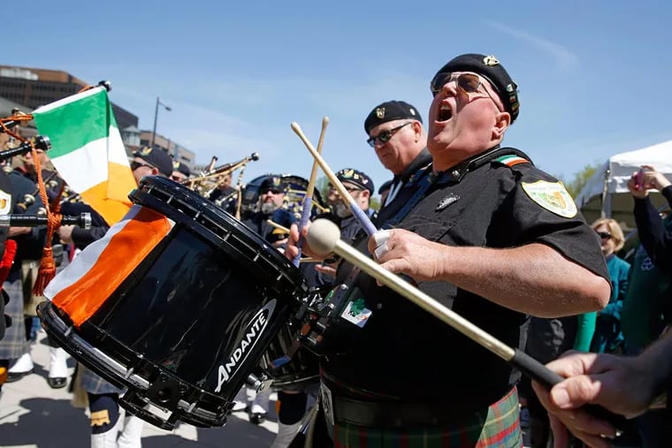 Dan Loftus, a drummer for the Brian Boru Pipes and Drums of Bridgeport, plays in front of Independence Hall.