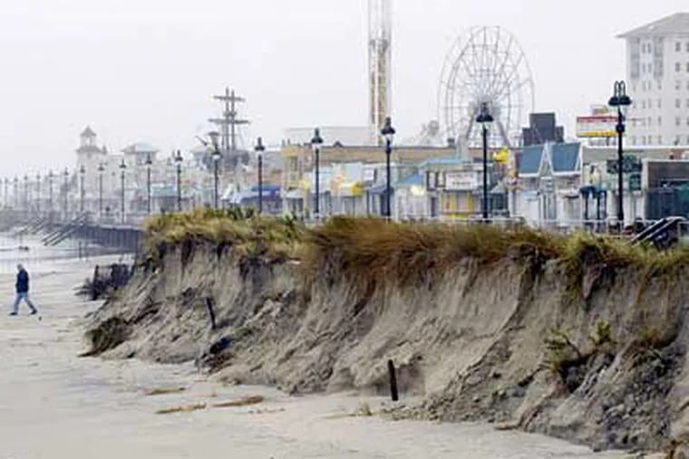 Cliffs of sand line the Ocean City boardwalk, the result of beach erosion from the nor'easter that has battered the Shore for the past two days. (Ron Tarver / Staff Photographer)