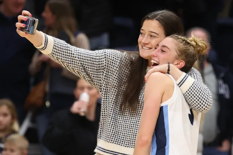Lucy Olsen (right) of Villanova poses for a photo with Villanova's all-time leading scorer Maddy Siegrist. Olsen went over 1,000 career points late in the game against Xavier on Dec. 30, 2023 at the Finneran Pavilion at Villanova University.  Olsen had 31 points in the game.
