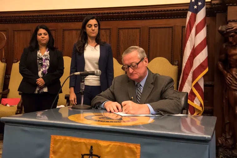 Mayor Jim Kenney signs an executive order instituting a new policy aimed at creating a better environment for reporting sexual harassment at City Hall on Thursday, July 19, 2018.