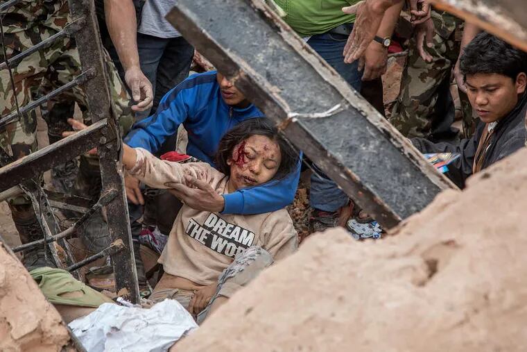 Rescue workers find a survivor amid debris in Kathmandu, Nepal.