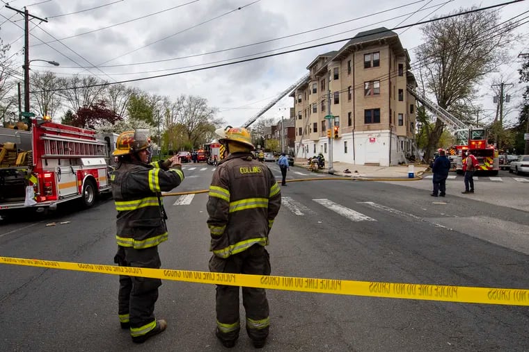 Firefighters survey the scene of a fire in April 2021. About 4% of the unionized workforce in the city's Fire Department were placed on leave for not complying with the administration's vaccine mandate.