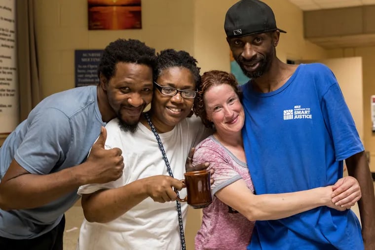 Margaux Murphy (second from right) founded the Sunday Love Project, a non-profit that serves meals to those in need. Murphy poses with regulars (from left) Lawrence Miller, Lisa Johnson and Warren Lane during the organization's weekly Monday brunch service.