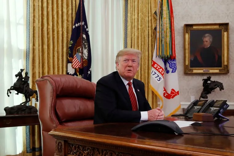 President Donald Trump answers questions from the media after speaking with members of the military by video conference on Christmas Day, Tuesday, Dec. 25, 2018, in the Oval Office of the White House.