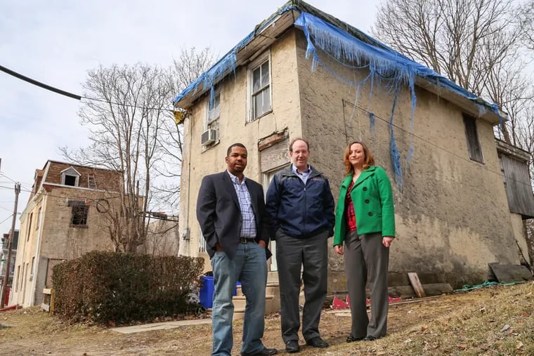 (From left) Developers Bruce McCall Jr., Ken Weinstein, and Nancy Deephouse, stand on the 100 block of Price Street in Germantown on Monday, Mar. 16 2015. The trio is part of Jumpstart Germantown, a mentoring program for developers which includes a two million dollar line of credit to help renovate homes in the area.