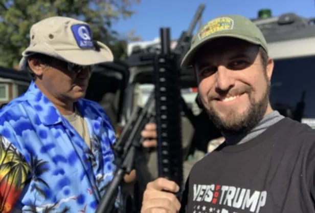 According to a court filing by the Philadelphia District Attorney this photograph found on Joshua Macias phone shows Antonio LaMotta left wearing a QAnon hat and Macias in a Vets for Trump shirt holding AR-15-style assault rifles