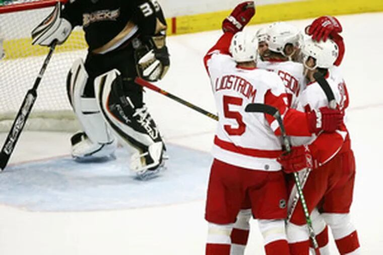 The Red Wings celebrate Tomas Holmstrom&#0039;s first-period goal in front of Anaheim goaltender Jean-Sebastien Giguere. Detroit won, 5-0, to take a two-games-to-one lead in the series.
