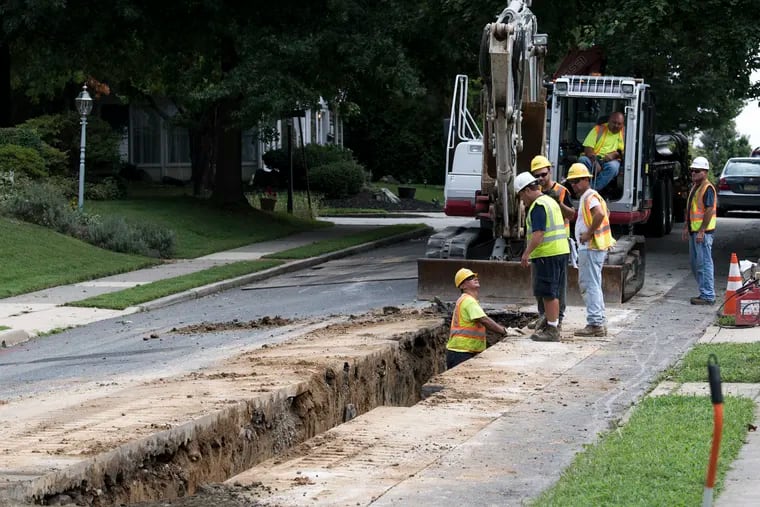 Investor owned utilities acknowledge that rates increase after they buy municipal systems, but say it's often because they make expensive infrastructure investments that public owners had neglected to do. Here, Aqua Pennsylvania contractors rebuild a water main on Hillcrest Road in Upper Darby.