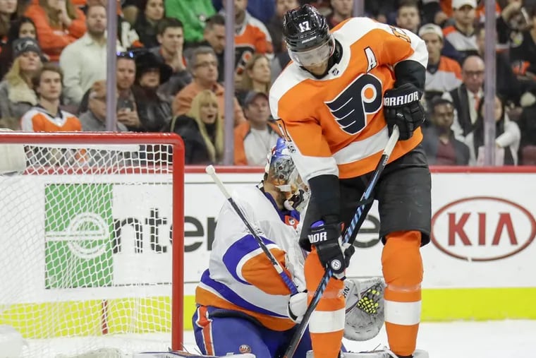 Flyers right wing Wayne Simmonds looks down at the puck against New York Islanders goalie Thomas Greiss during a Flyers third-period power play on Friday, November 24, 2017 in Philadelphia. YONG KIM / Staff Photographer