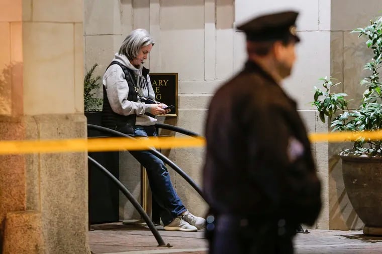 The off-duty FBI agent involved in a fatal shooting of a pitbull on the 1500 block of Spruce Street Monday night sits nearby as police investigate the scene. Sources identified the agent Tuesday as Jacqueline Maguire, head of the bureau's Philadelphia Field Office.