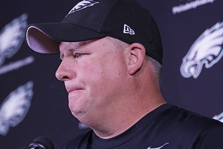 Chip Kelly listens to questions from the media. (Michael Bryant/Staff Photographer)