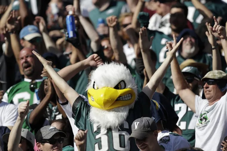 Happy Eagles fan cheer after their team scored a touchdown in the fourth-quarter against the Los Angeles Chargers on Sunday, October 1, 2017 in Carson, CA. YONG KIM / Staff Photographer