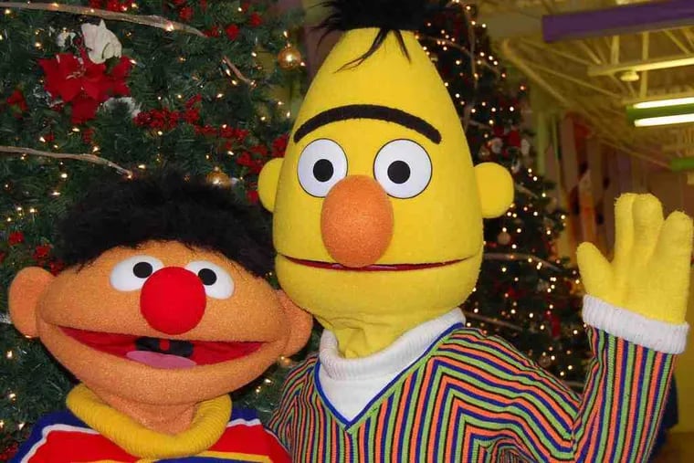 Bert and Ernie by a Christmas Tree during last year's holiday party at Sesame Place.