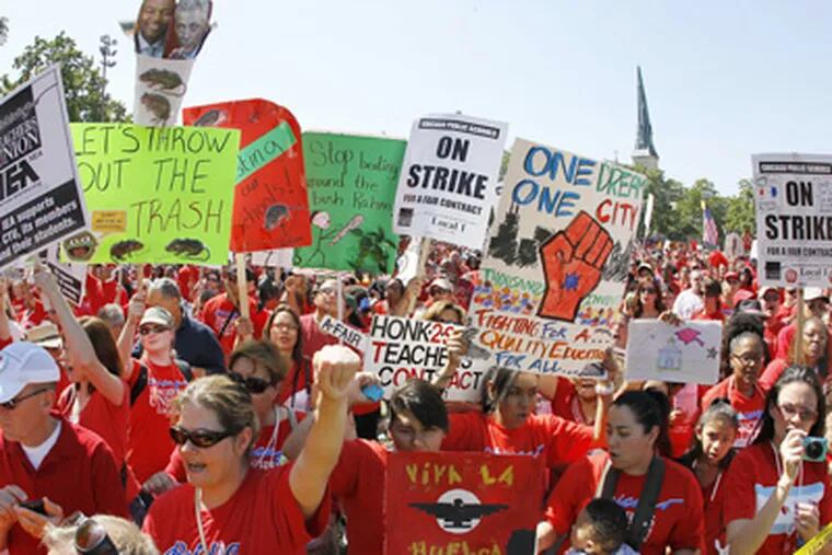 Striking Chicago school teachers rally at Union Park Saturday, Sept.; 15, 2012, in Chicago. Union president Karen Lewis reminded the crowd; that although there is a "framework" for an end to their strike, they; still are on strike.(AP Photo/Charles Rex Arbogast)