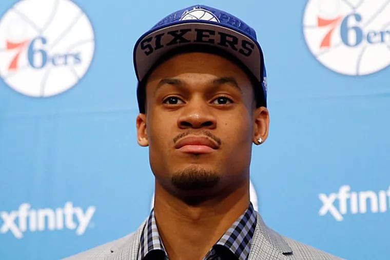 K.J. McDaniels poses for a photo after a basketball news conference at the team's practice facility, Saturday, June 28, 2014, in Philadelphia. (Matt Slocum/AP)