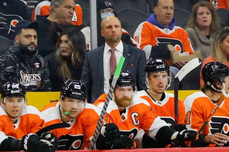 Flyers interim coach Mike Yeo behind the bench against the Colorado Avalanche on Monday. The Avs won, 7-5.