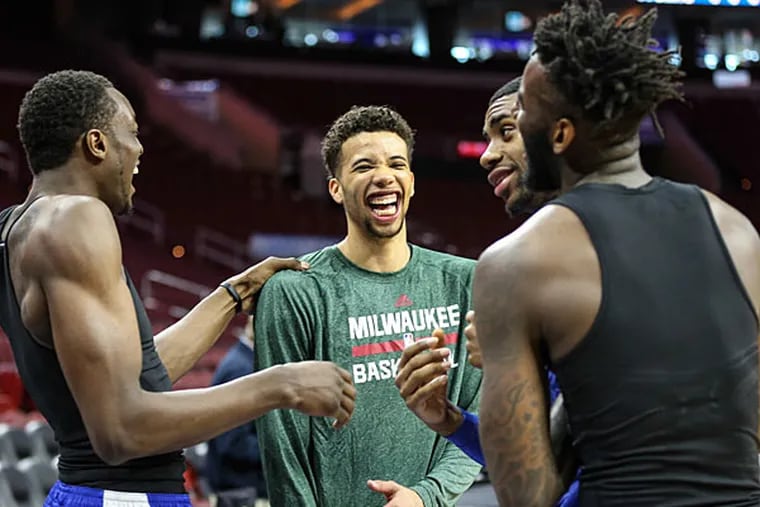 Jerami Grant (left) and Hollis Thompson and Jakarr Sampson (right) joke as they welcome Michael Carter-Williams back to the Wells Fargo Center. (Steven M. Falk/Staff Photographer)