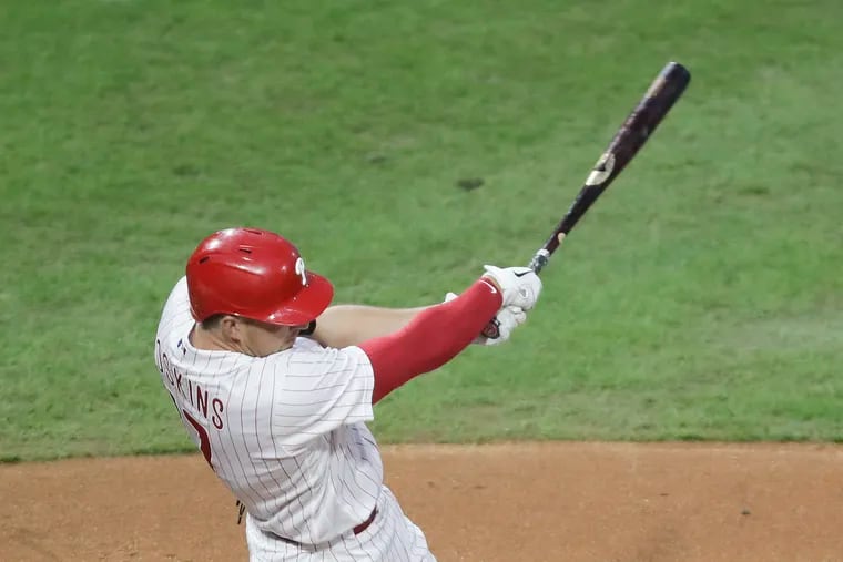 Rhys Hoskins follows through on a fifth-inning, three-run double that broke the game open for the Phillies Saturday night. They went on to beat the Mets, 6-2.