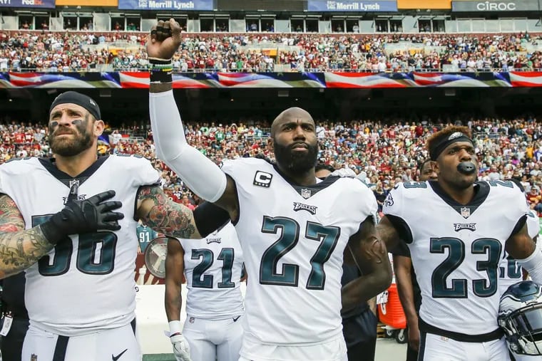 Malcolm Jenkins (center) and defensive end Chris Long (left) have already said they won’t be attending the Eagles’ White House visit.