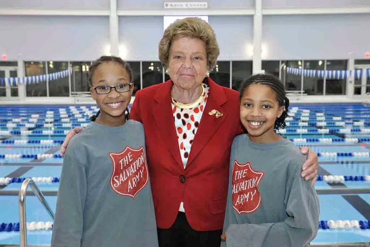 Betty Moran, a lead donor for the Salvation Army Ray and Joan Kroc Center, with Badia Weeks (left), 10, and Madison Freeland, 10, who are practicing with Jim Ellis, the center's senior aquatics director, for the Jan. 8 swim team tryouts.